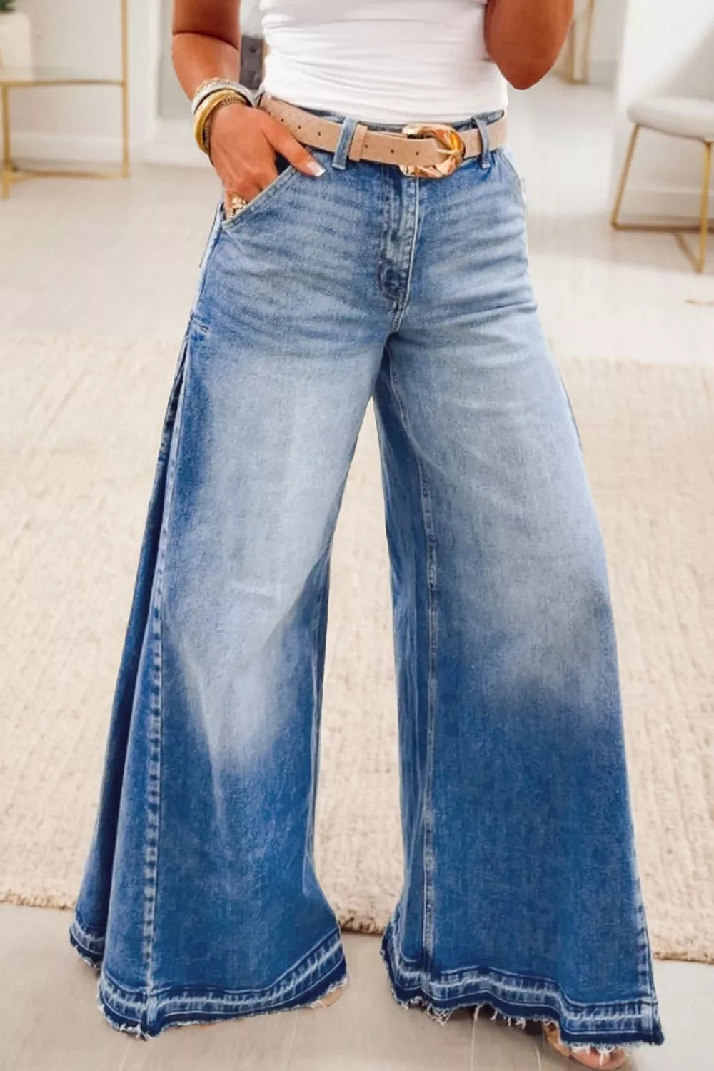 Dusty blue flare leg jeans with side seam gathering from Trendsi, showcasing a stylish, fitted silhouette and classic denim texture.