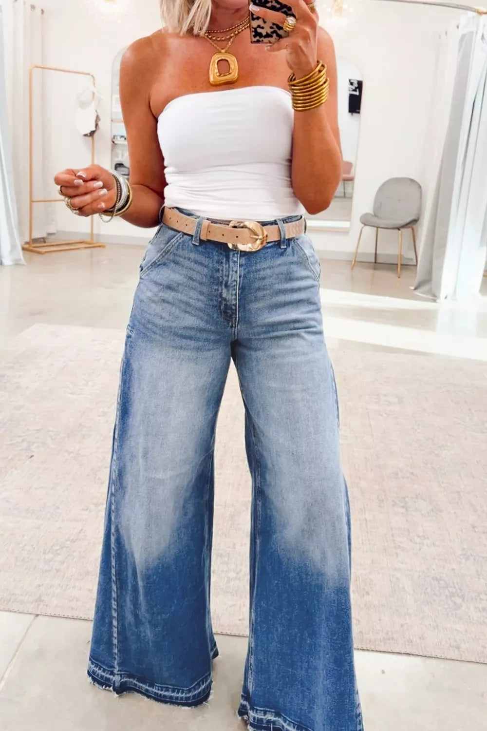 Dusty blue flare leg jeans with side seam gathering from Trendsi, showing the fit and stylish design from the side view.