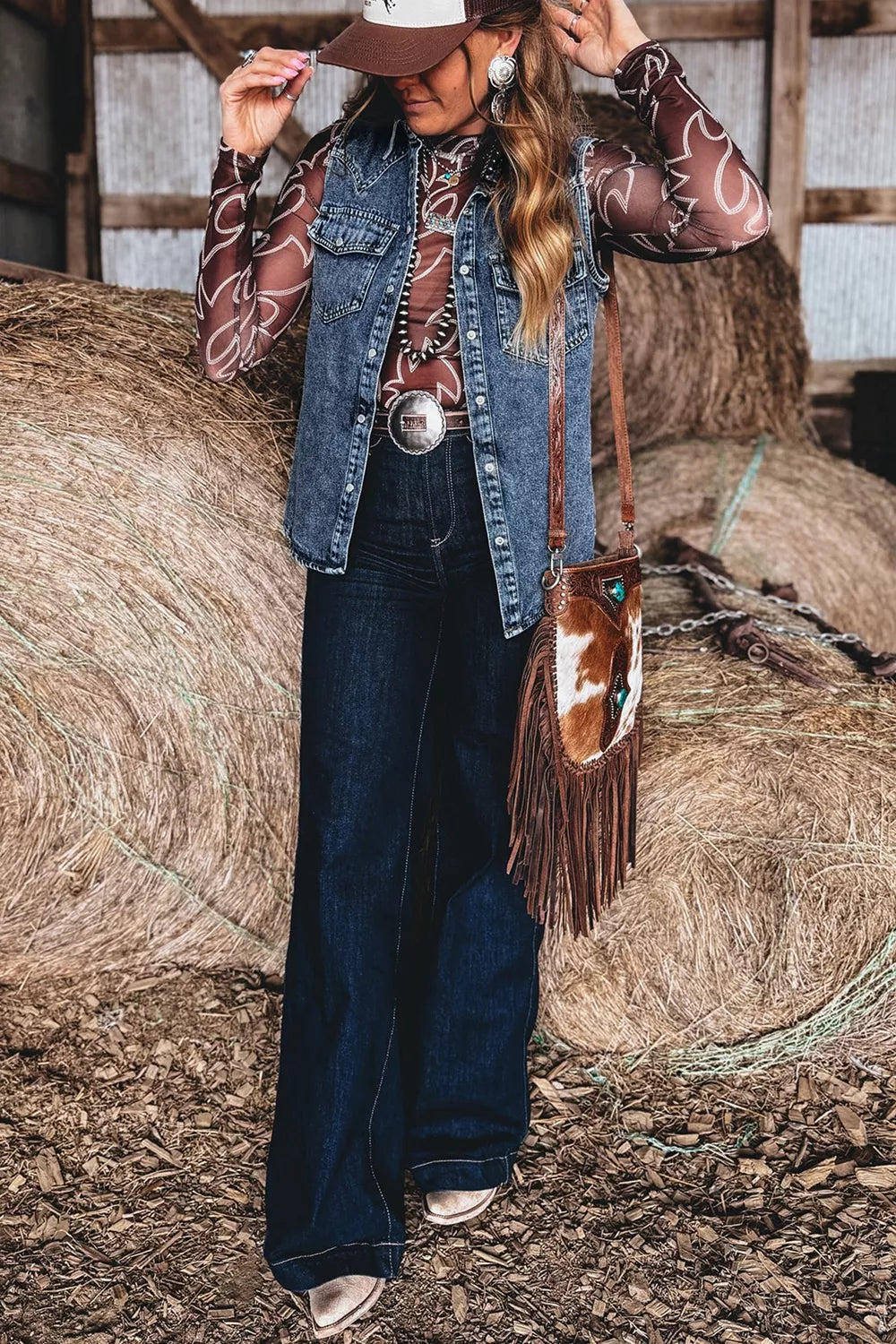 Blue solid denim sleeveless cowboy vest with button front and front pockets from Trendsi, featuring a casual western style.