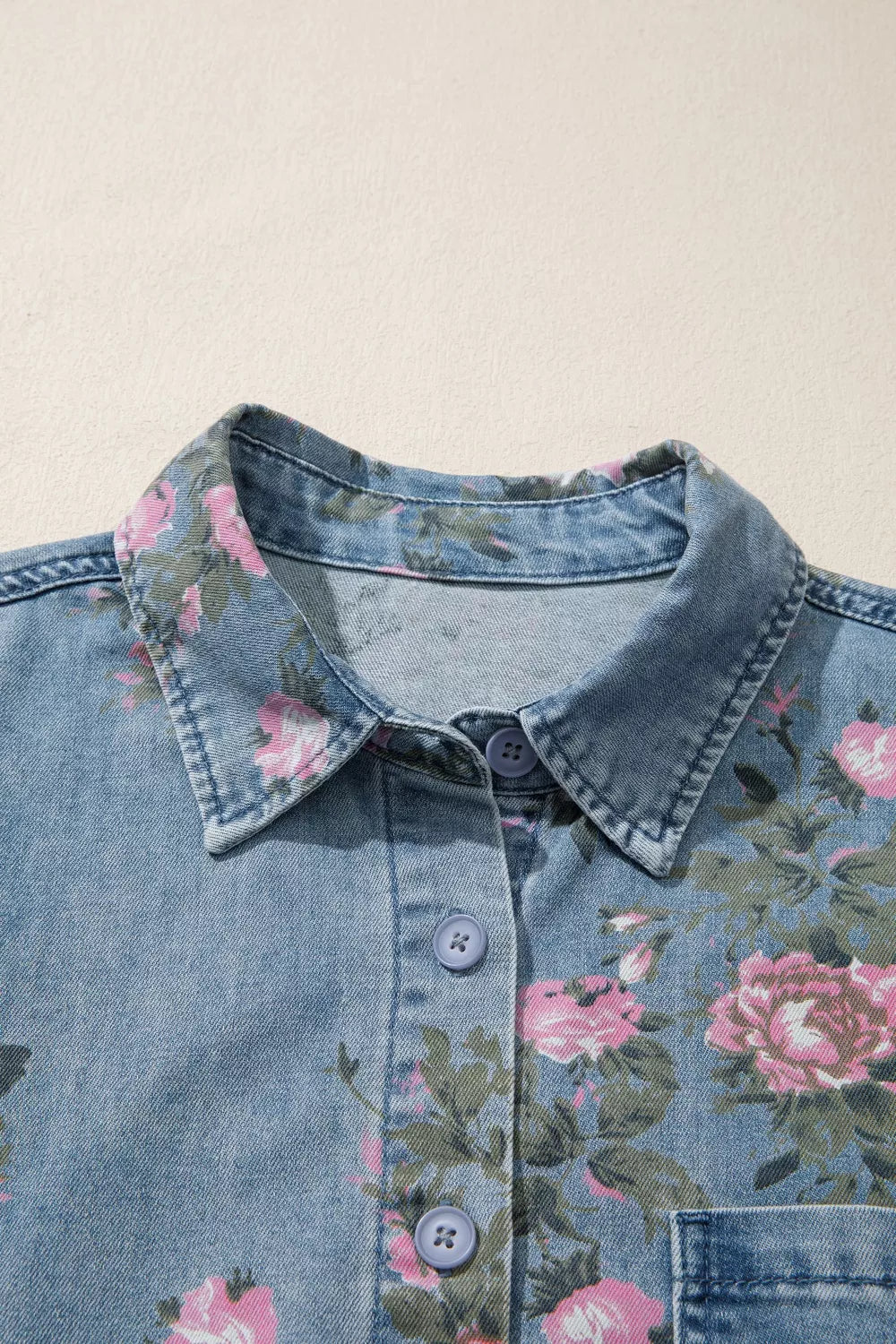 Dusty blue floral print denim shirt by Trendsi, front view showcasing button-up design and vibrant floral pattern.