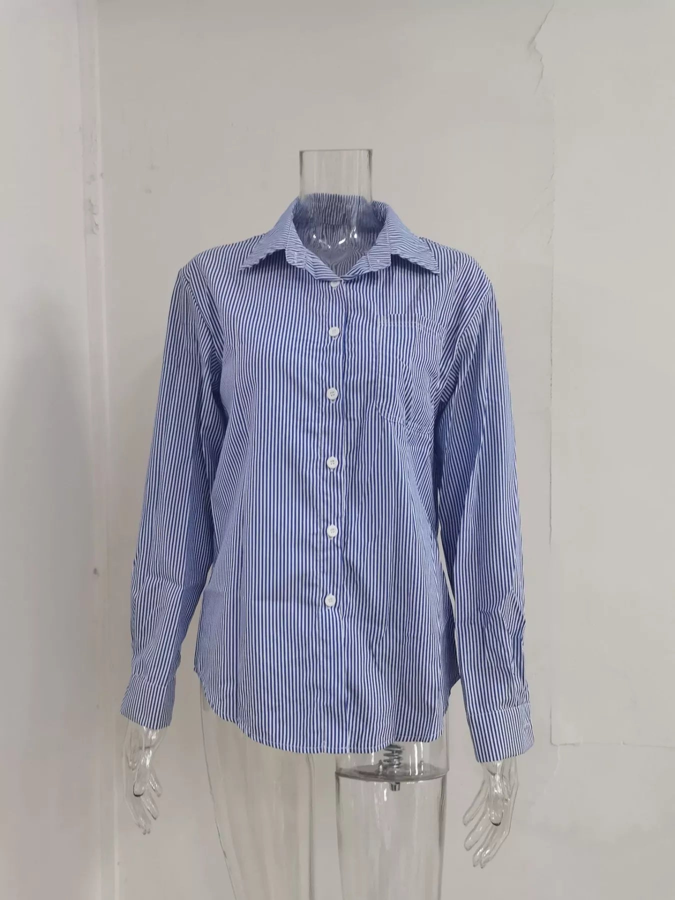 Relaxed fit striped button-down shirt from Trendsi, featuring a casual style with vertical stripes and a classic collar.