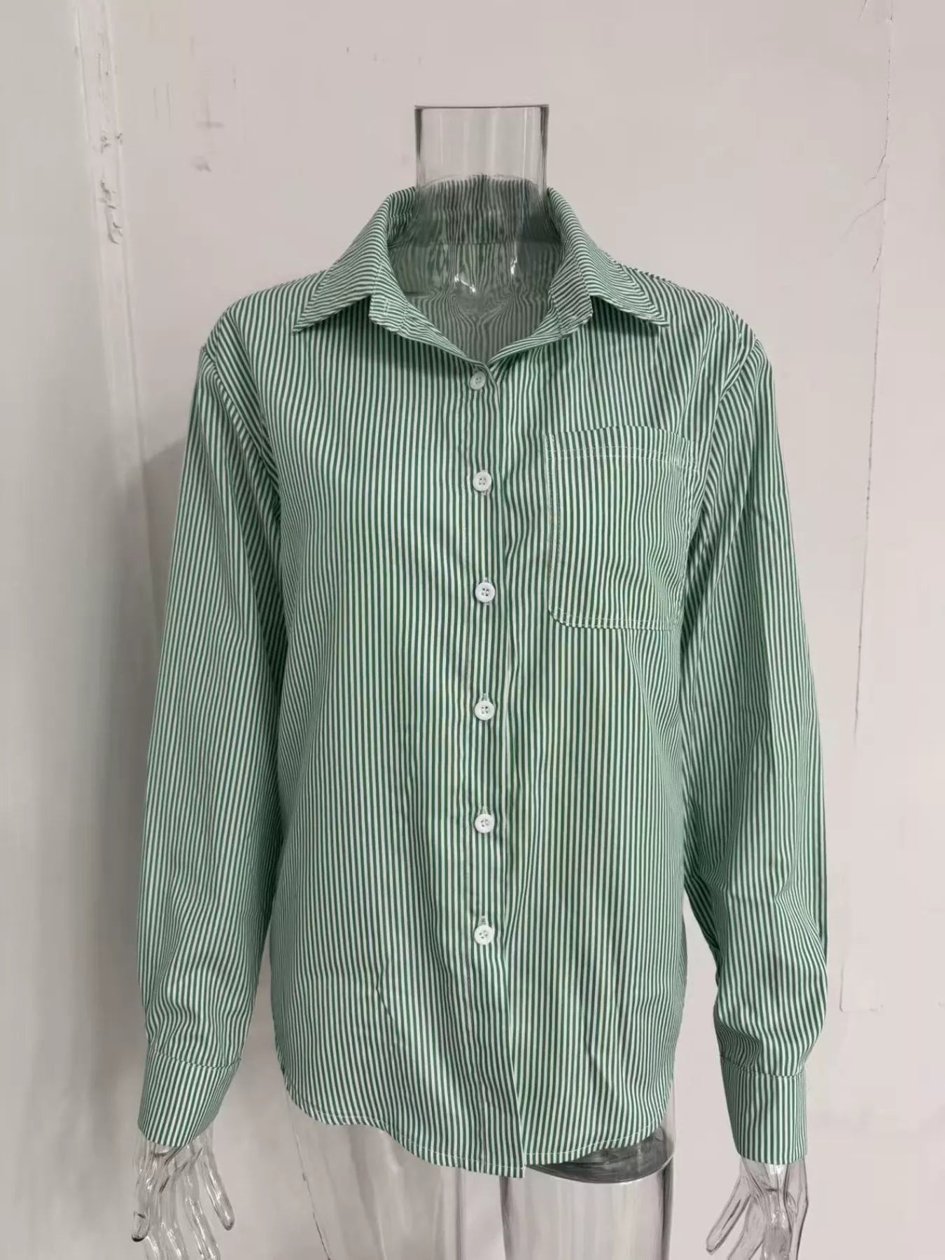 Striped button-down relaxed fit shirt by Trendsi, featuring a casual style with vertical stripes and a classic collar.