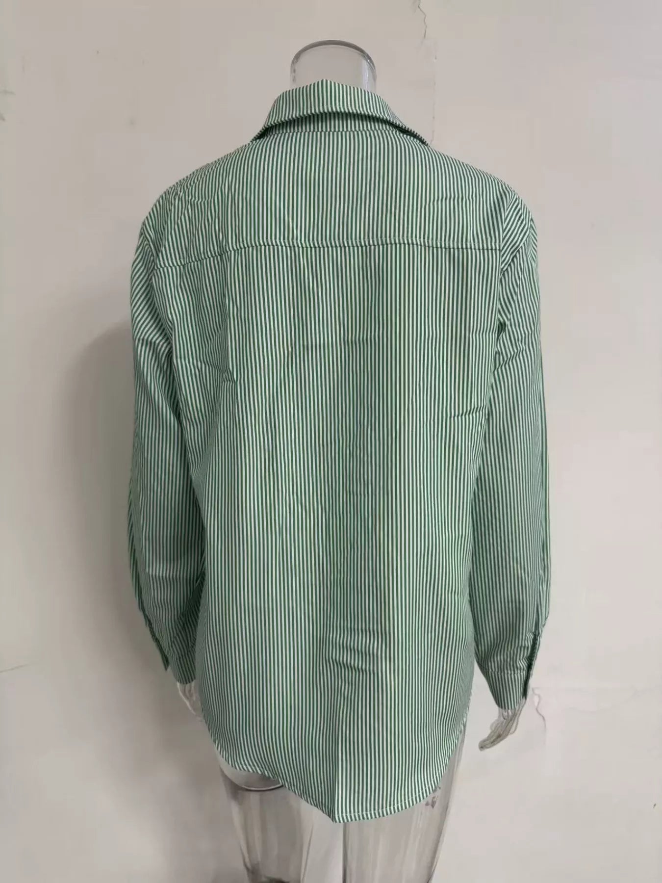 Relaxed fit striped button-down shirt from Trendsi, featuring a casual design with vertical blue and white stripes.