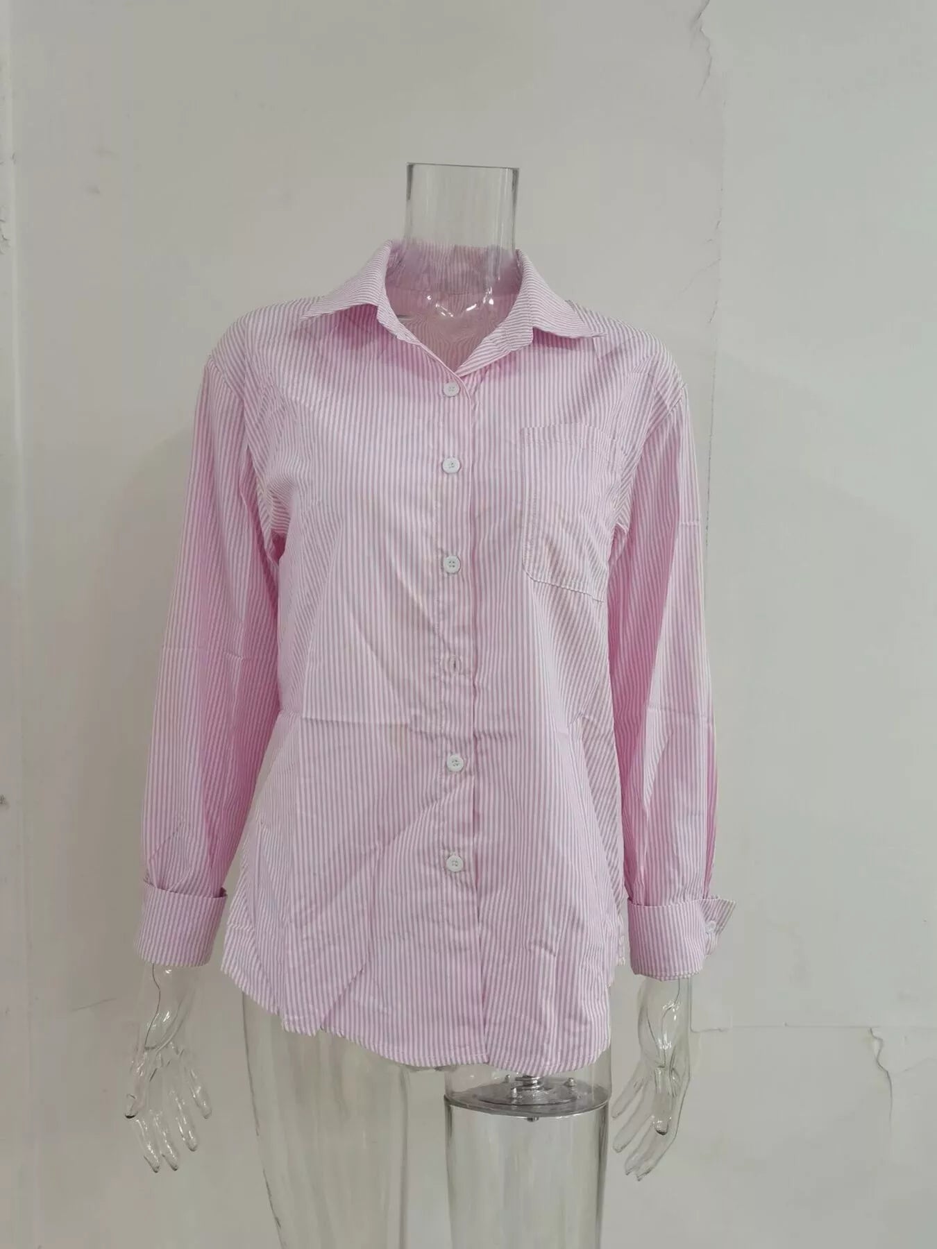 Relaxed fit striped button-down shirt by Trendsi featuring a classic collar and long sleeves, displayed on a hanger.