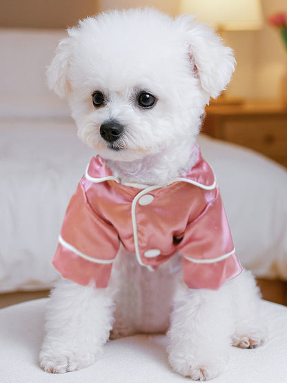 Dusty pink satin pet pajamas with contrast piping and adjustable straps, designed for comfort and style.