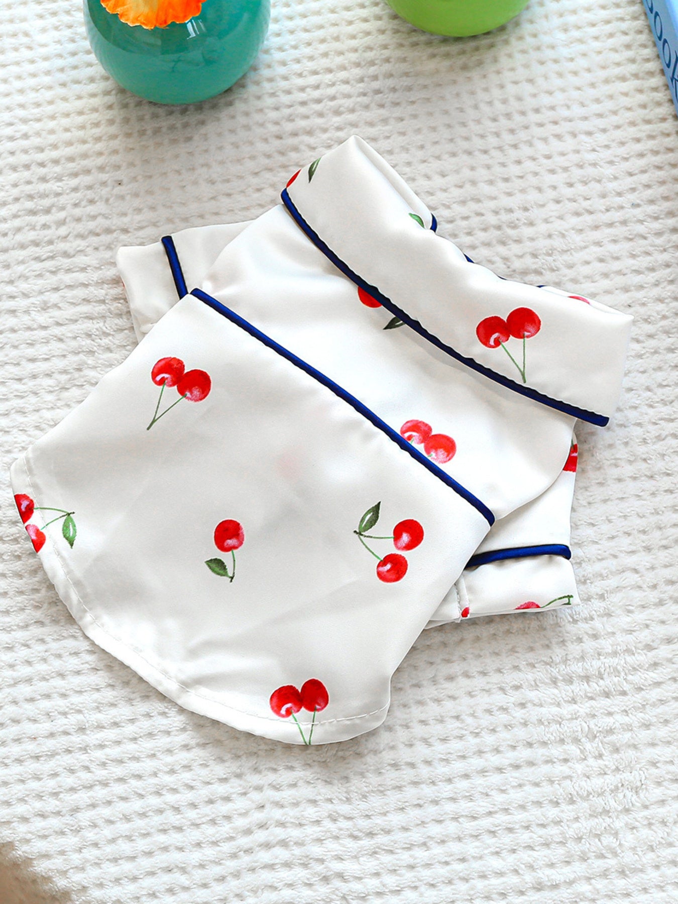 Dusty pink satin pet pajamas with contrast piping, featuring comfortable design and adjustable fit for pets.