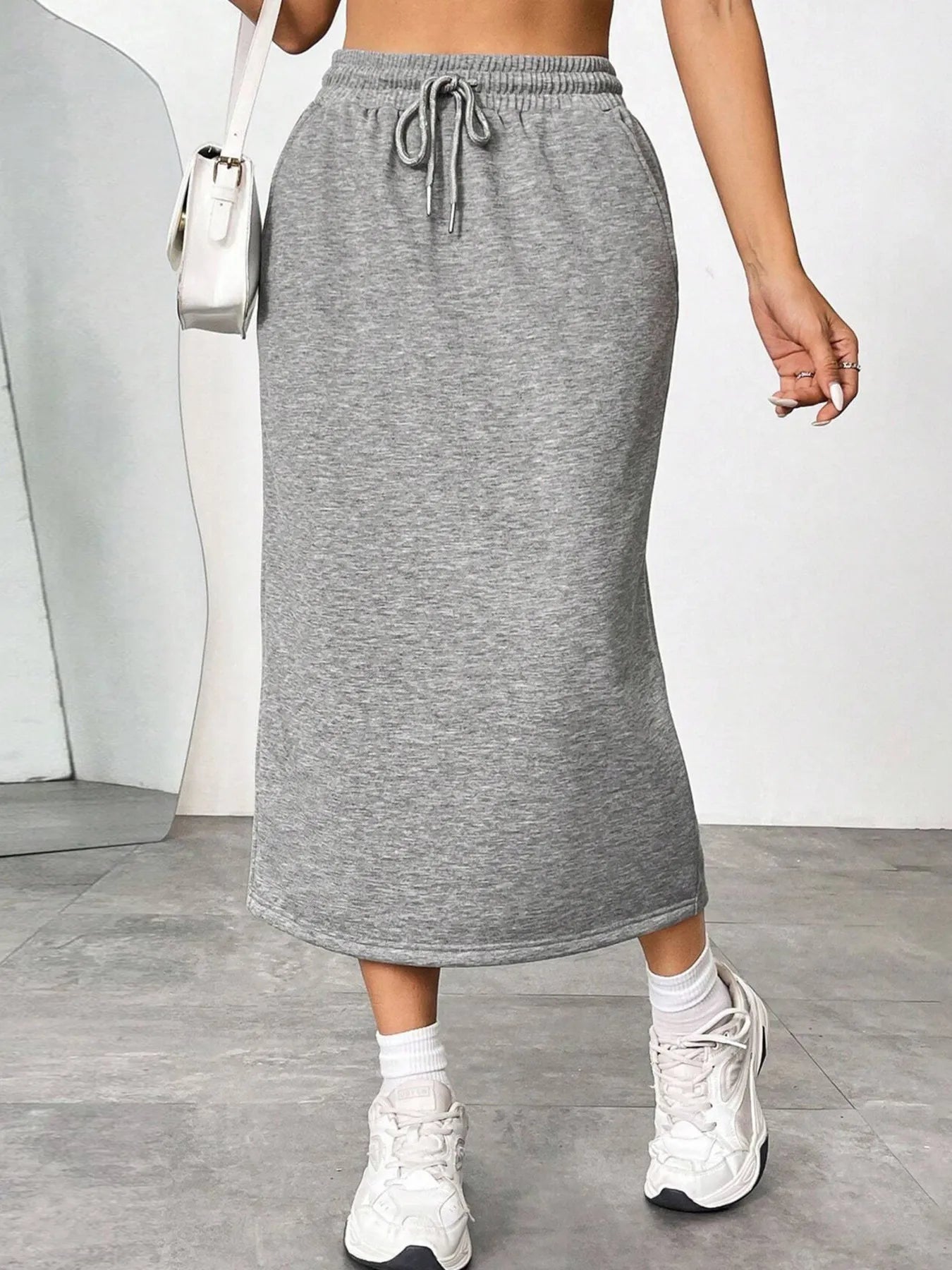 Trendsi slit drawstring midi skirt featuring a flowy design and high waist, shown in a stylish, lightweight fabric.
