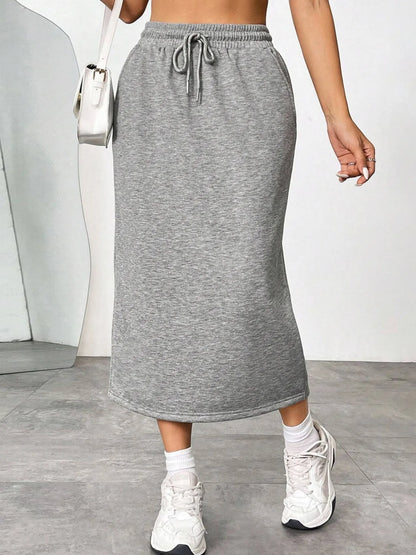 Trendsi slit drawstring midi skirt featuring a flowy design and high waist, shown in a stylish, lightweight fabric.