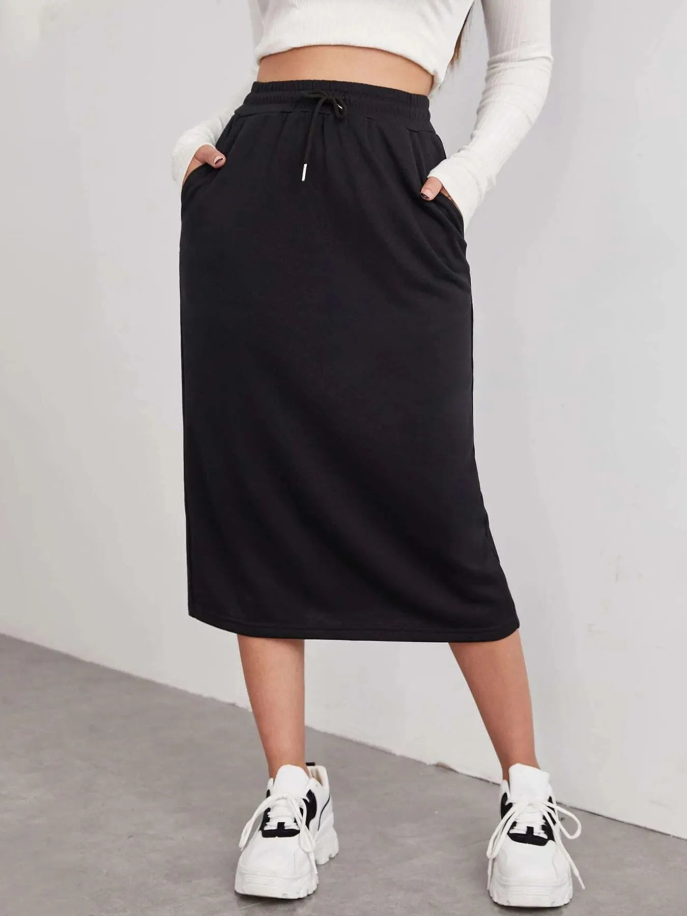 Trendsi slit drawstring midi skirt in flowy fabric with side slit and adjustable waist, styled for casual or dressy looks.