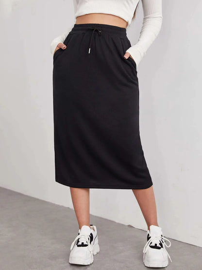 Trendsi slit drawstring midi skirt in flowy fabric with side slit and adjustable waist, styled for casual or dressy looks.