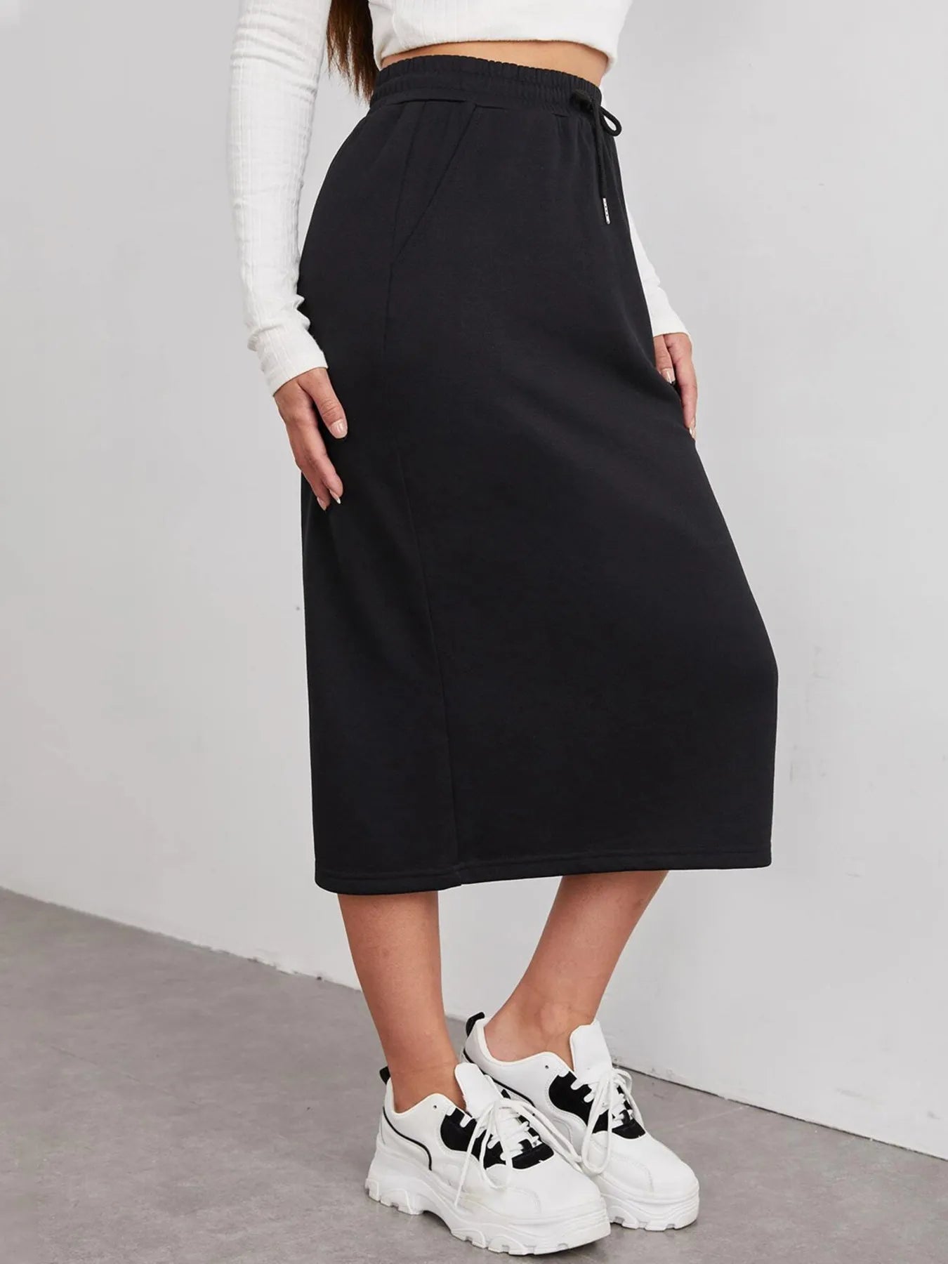 Trendsi slit drawstring midi skirt in a flowy fabric with side slit and adjustable waist, stylish and versatile for casual or dressy wear.