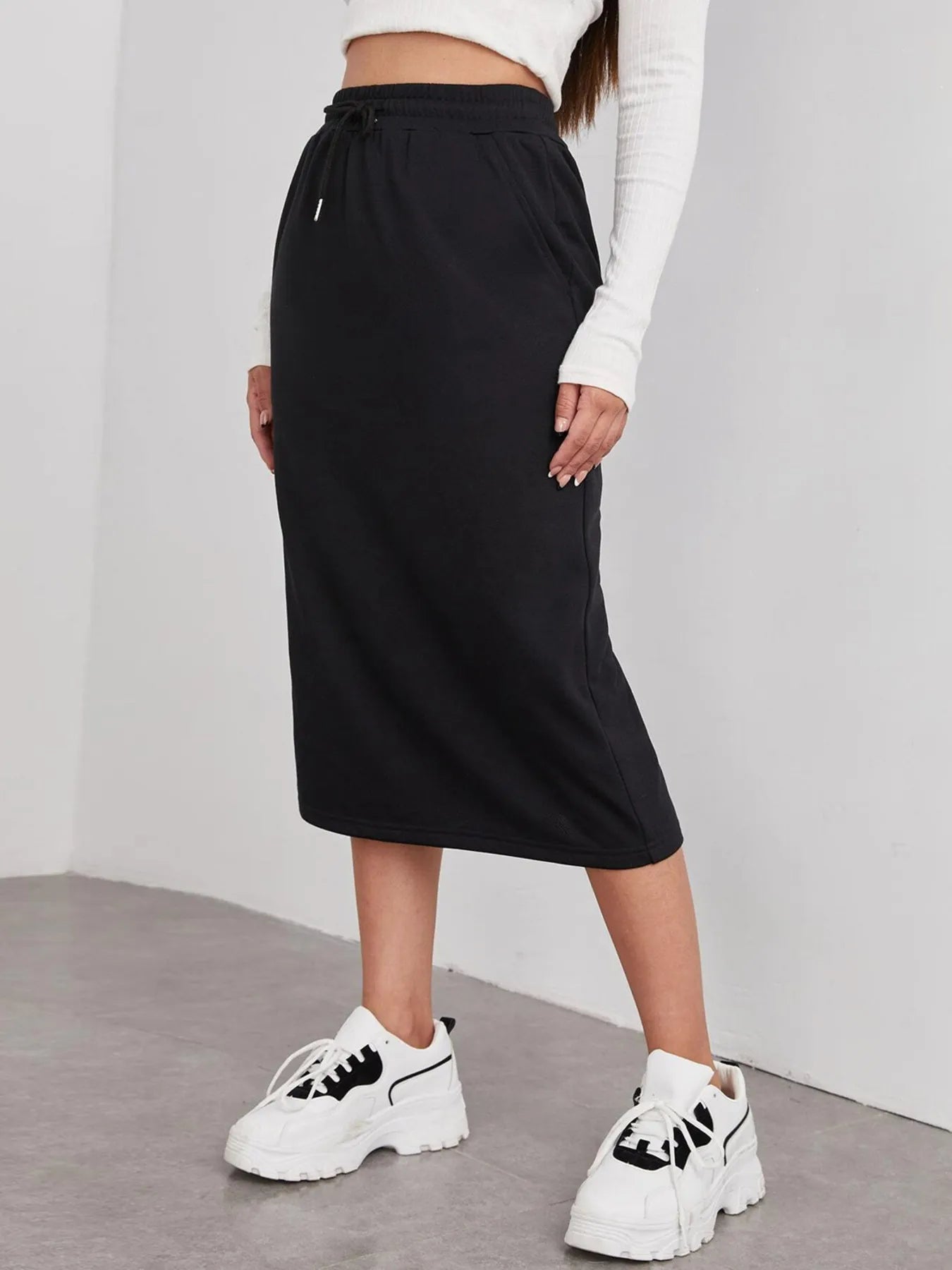 Trendsi slit drawstring midi skirt with side slit, lightweight fabric, and adjustable waistband, shown on a model.