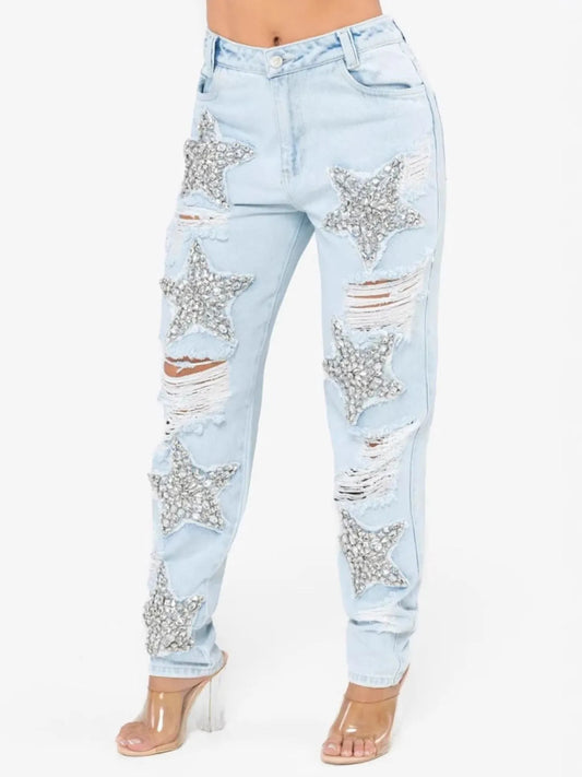 Blue distressed star wash boyfriend jeans from Trendsi featuring a relaxed fit and trendy design.