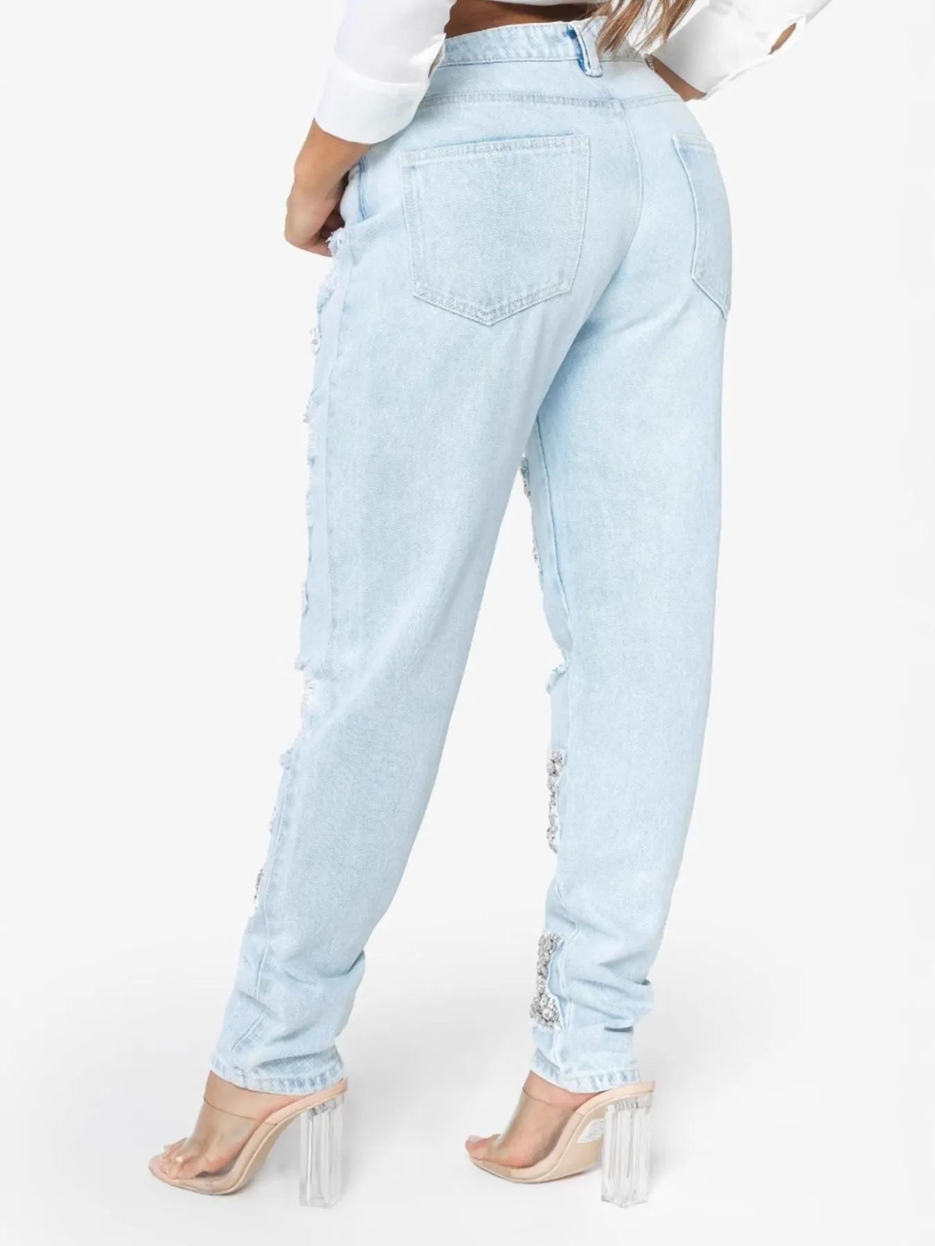 Light blue distressed star wash boyfriend jeans by Trendsi, featuring a relaxed fit and casual style.