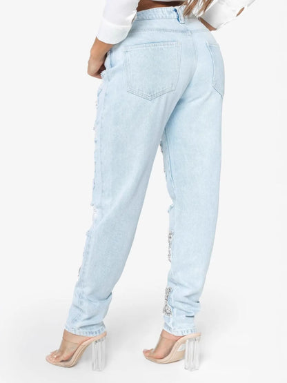 Light blue distressed star wash boyfriend jeans by Trendsi, featuring a relaxed fit and casual style.