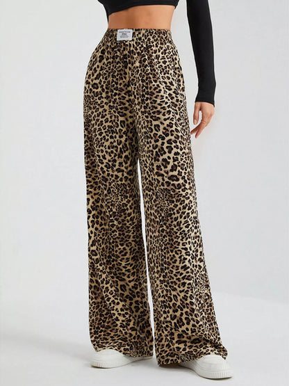 Plus size leopard print wide leg pants by Trendsi featuring a bold animal pattern and relaxed fit, full-length design.