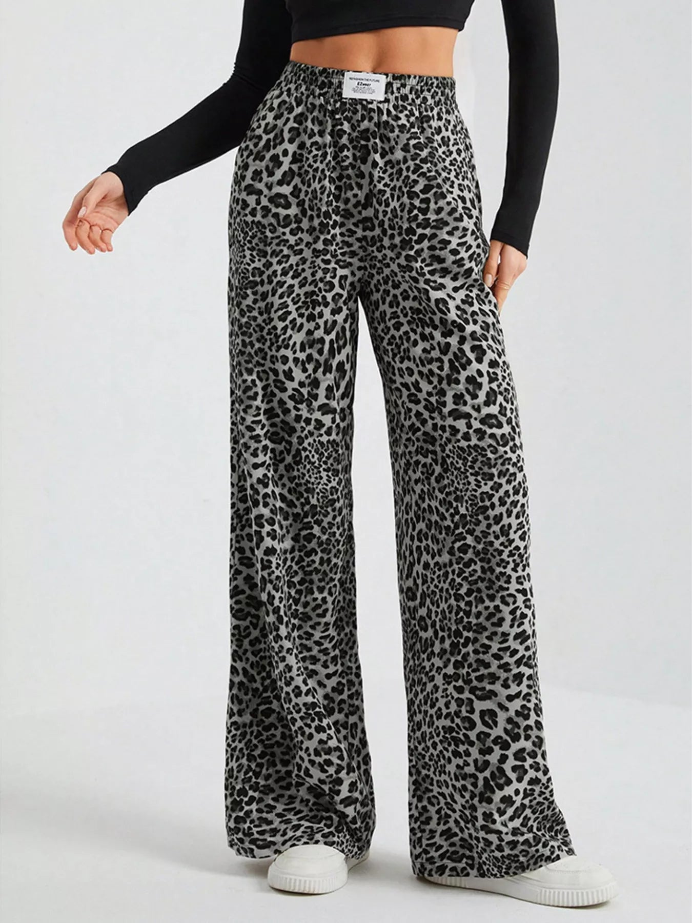 Plus size leopard print wide leg pants by Trendsi, full-length view showing the stylish, flowy design and bold animal print.