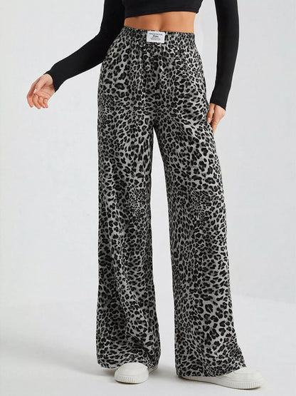 Plus size leopard print wide leg pants by Trendsi, full-length view showing the stylish, flowy design and bold animal print.