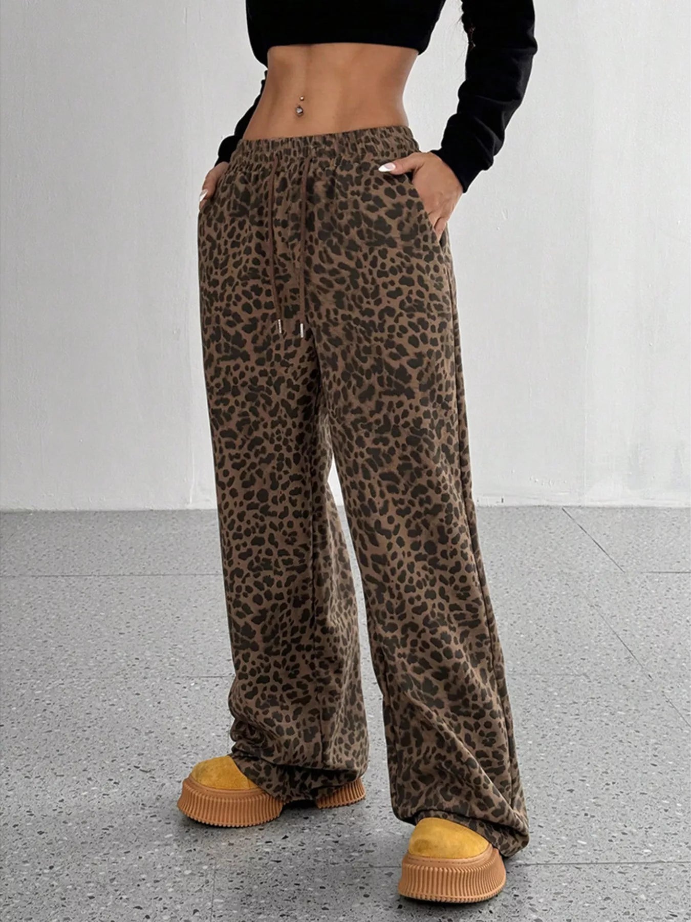 Plus size leopard print wide leg pants by Trendsi featuring bold animal print and flowing fit, perfect for casual or stylish looks.