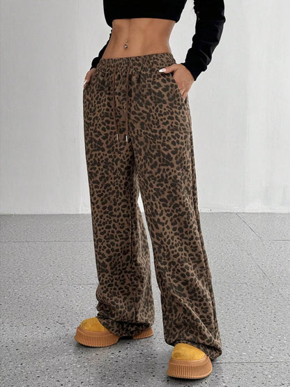 Plus size leopard print wide leg pants by Trendsi featuring bold animal print and flowing fit, perfect for casual or stylish looks.