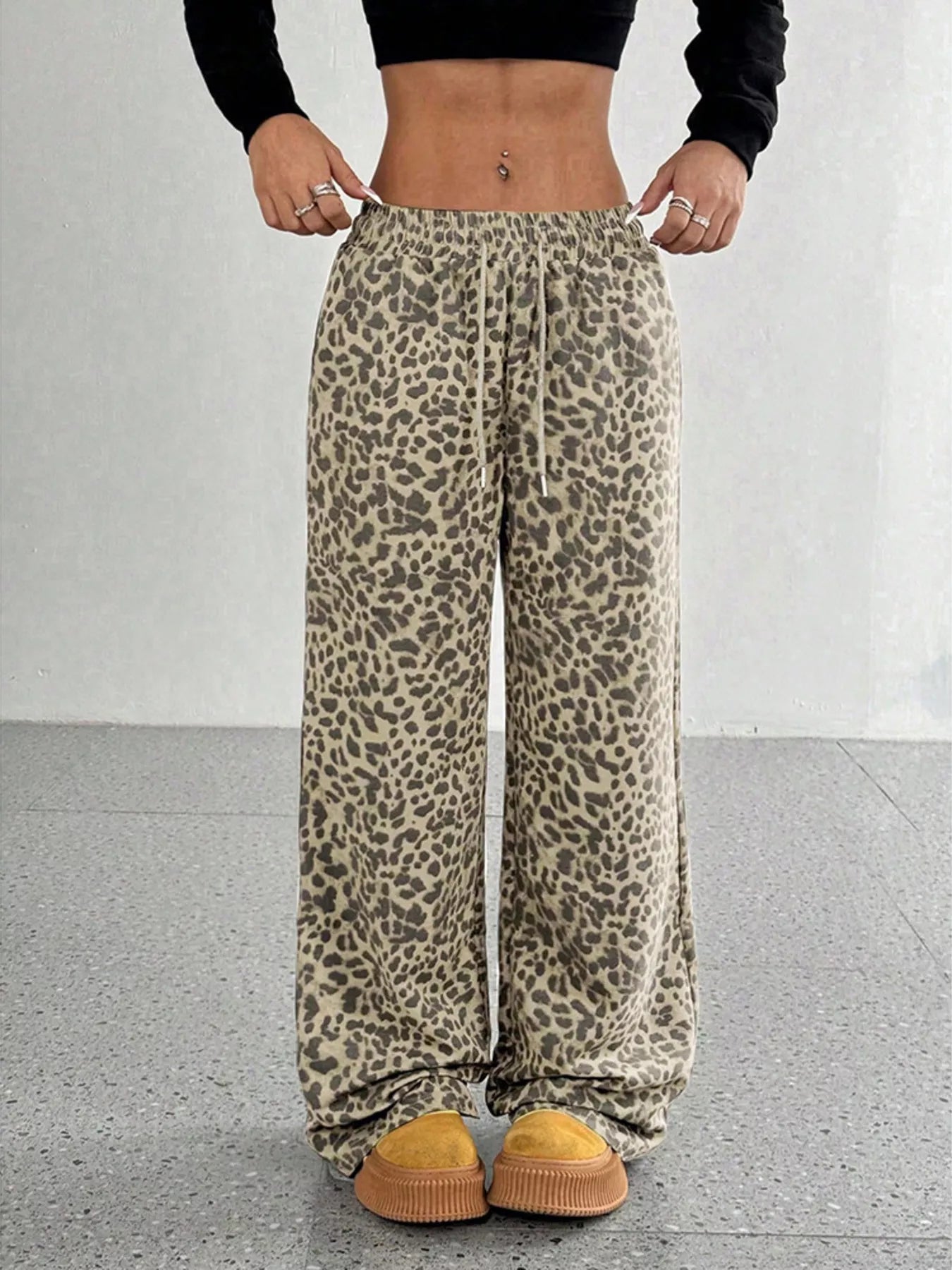 Plus size leopard print wide leg pants by Trendsi, showing the full length and bold animal pattern on lightweight fabric.