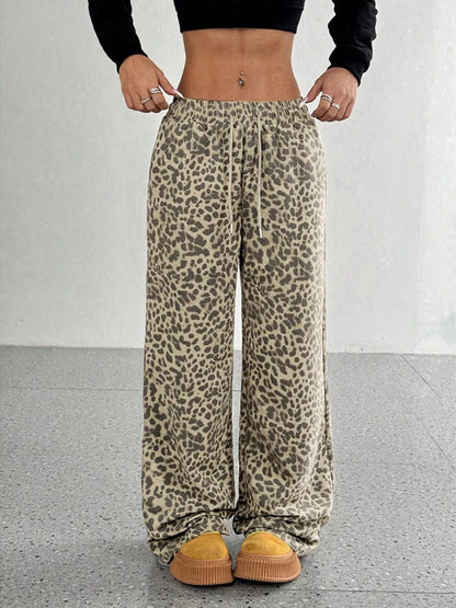 Plus size leopard print wide leg pants by Trendsi, showing the full length and bold animal pattern on lightweight fabric.