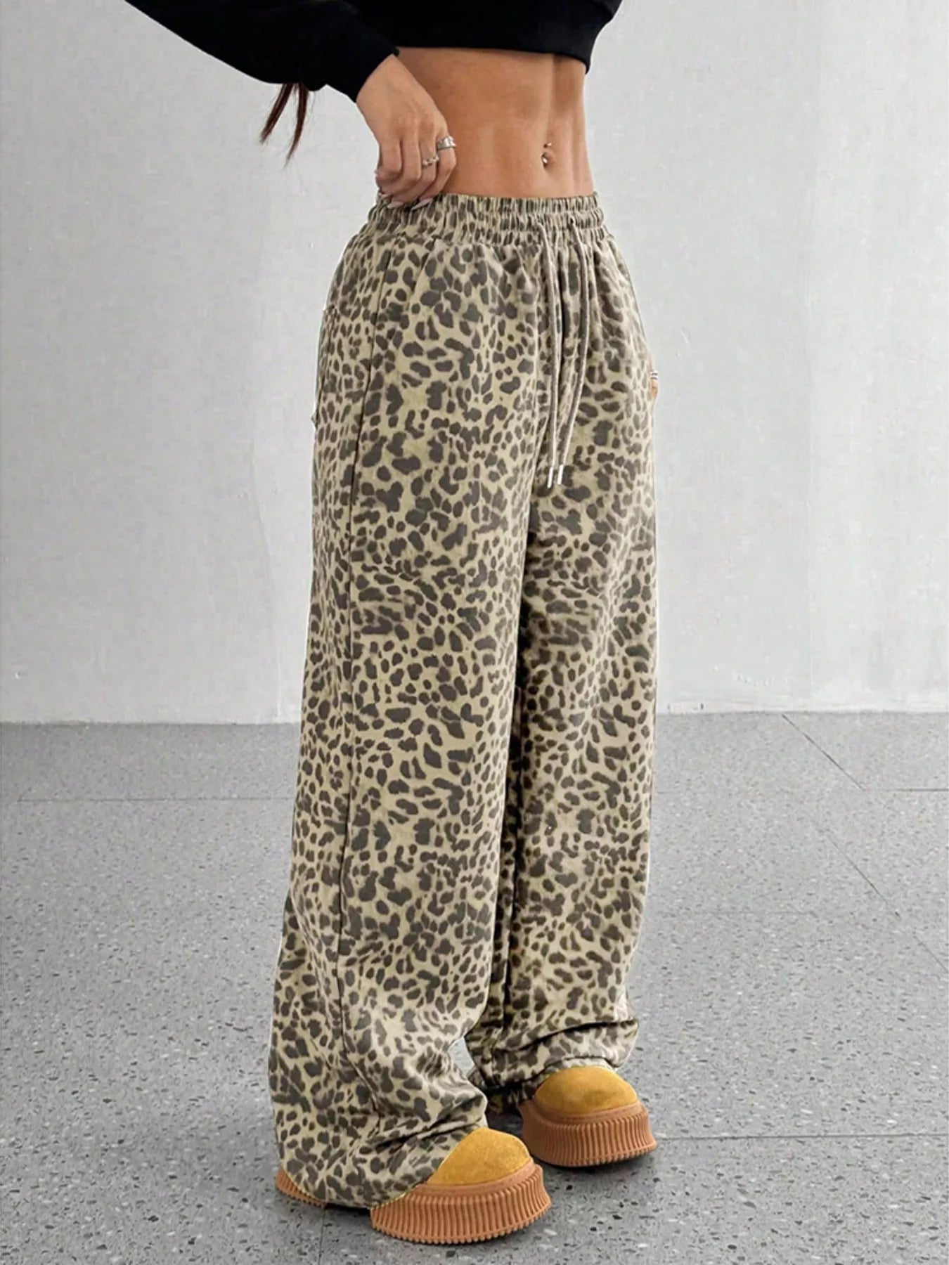 Plus size leopard print wide leg pants by Trendsi, full length view showcasing stylish, comfortable fit and bold animal print design.