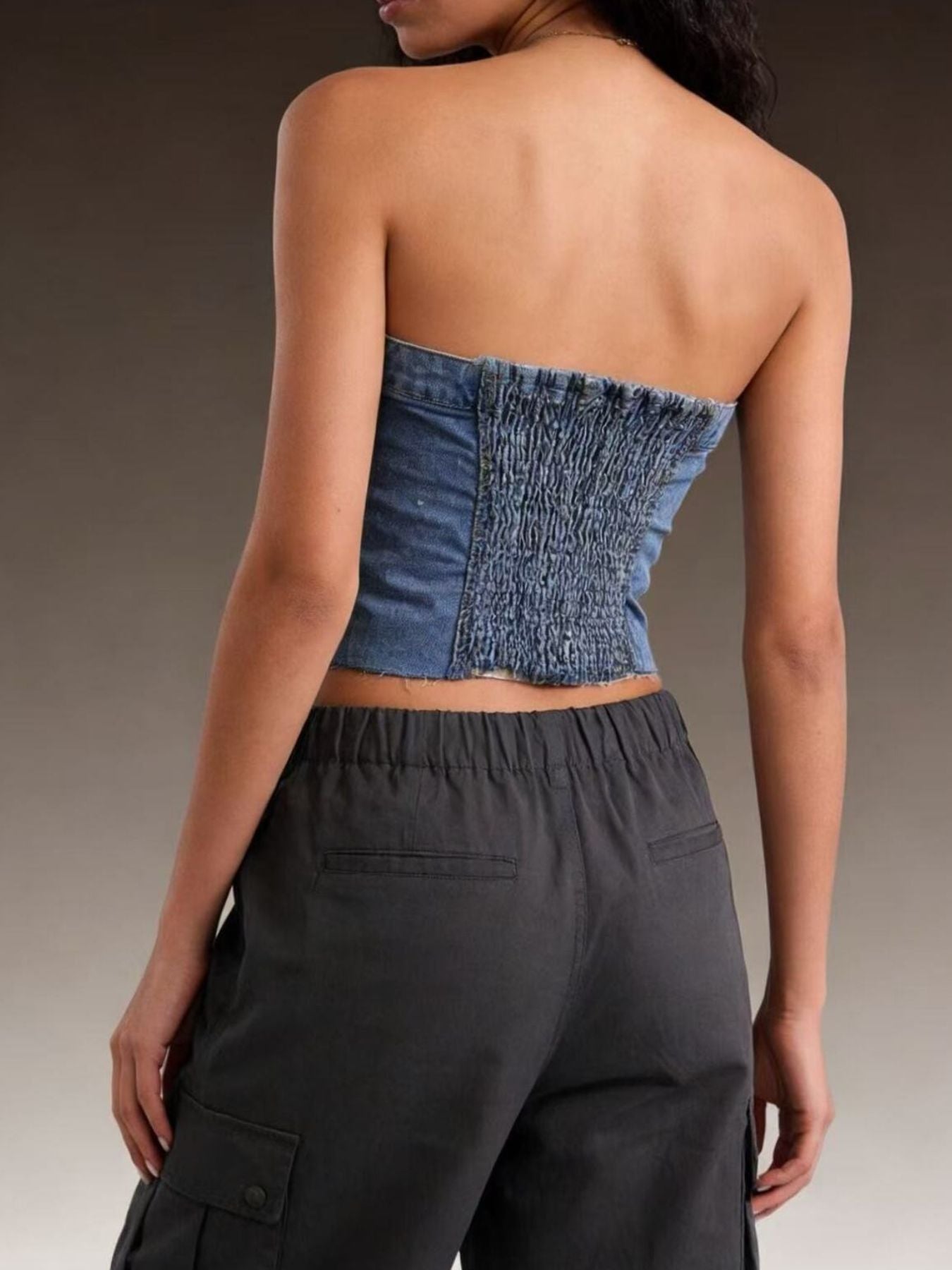 Light blue button-front strapless denim top from Trendsi, featuring a fitted design and sleeveless style.