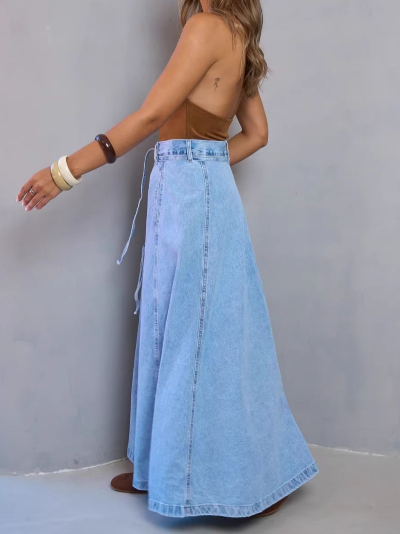 Light blue high-waisted denim skirt by Trendsi featuring a classic fit and front pockets.