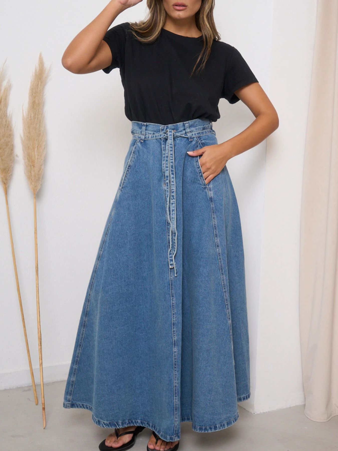Light blue high-waisted denim skirt by Trendsi, shown with a fitted silhouette and classic denim details.