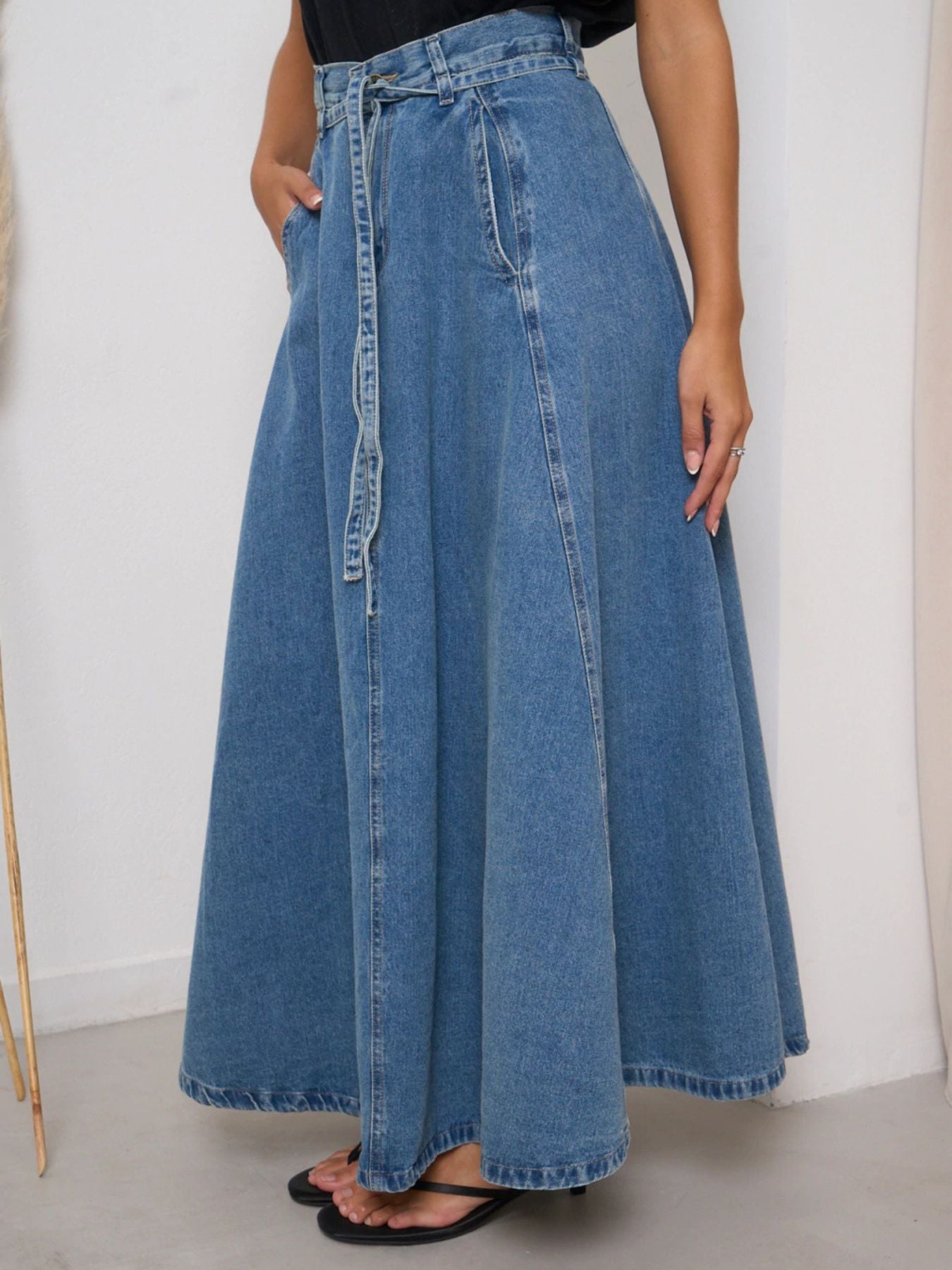 Light blue high-waisted denim skirt by Trendsi, featuring a classic fit and stylish design perfect for casual wear.