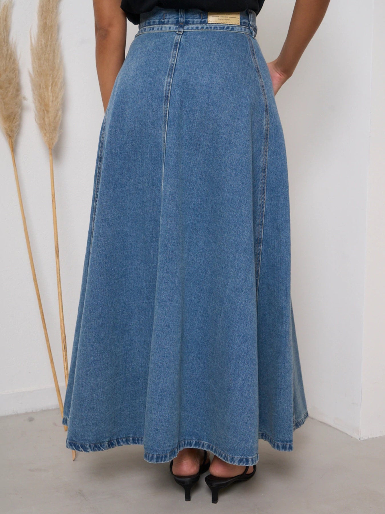 Light blue high-waisted denim skirt by Trendsi, showcasing a fitted waist and classic denim texture.