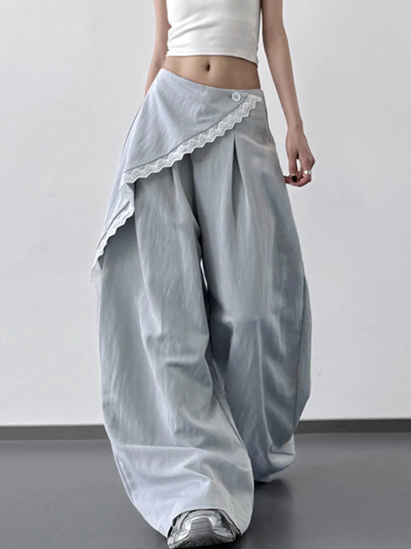 Light blue lace detail wide leg pants by Trendsi, featuring a relaxed fit and elegant lace accents for a stylish look.