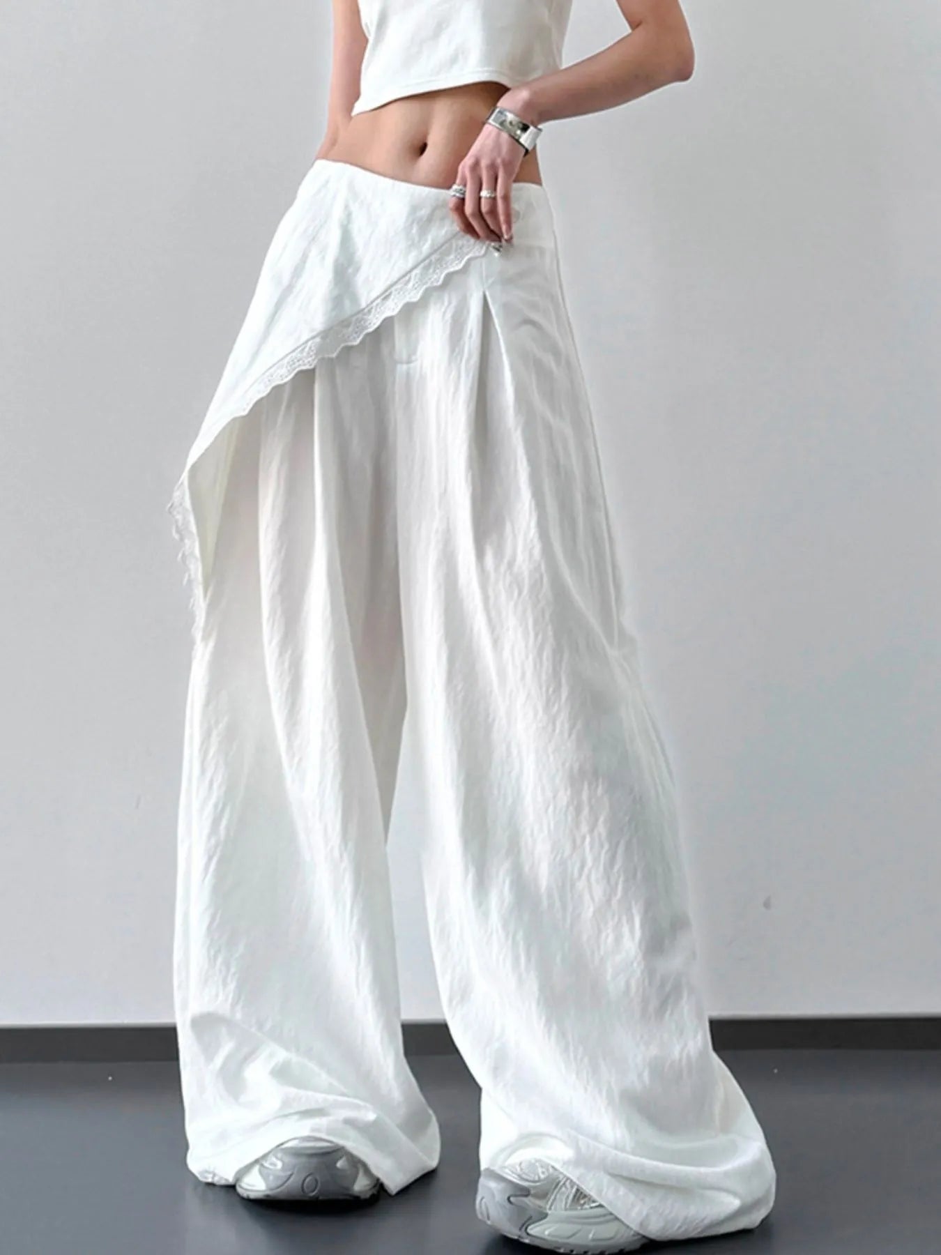 Light blue lace detail wide leg pants by Trendsi, featuring flowy fabric and elegant design for a relaxed, stylish look.