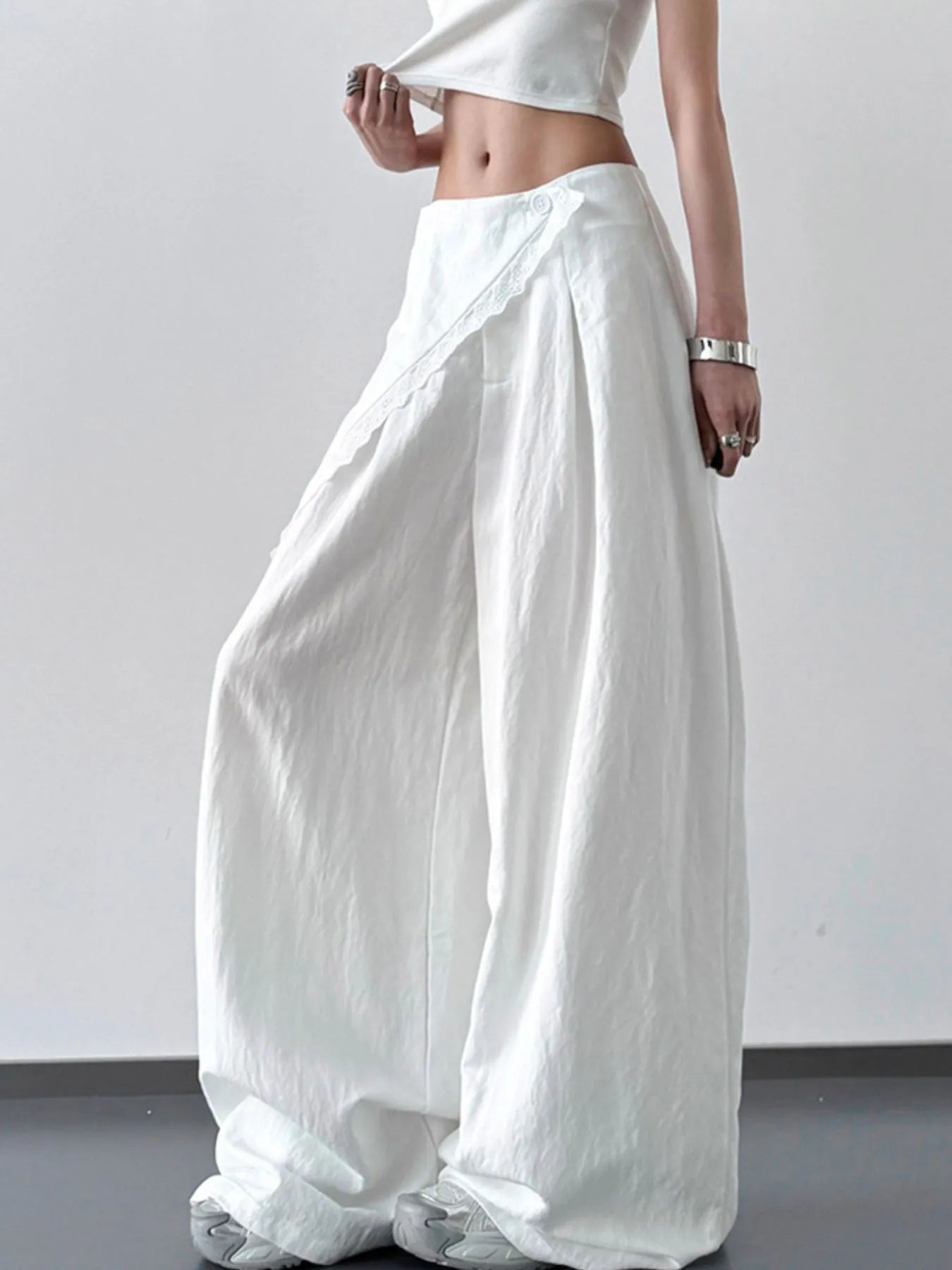 Light blue lace detail wide-leg pants by Trendsi featuring flowing fabric and elegant design.