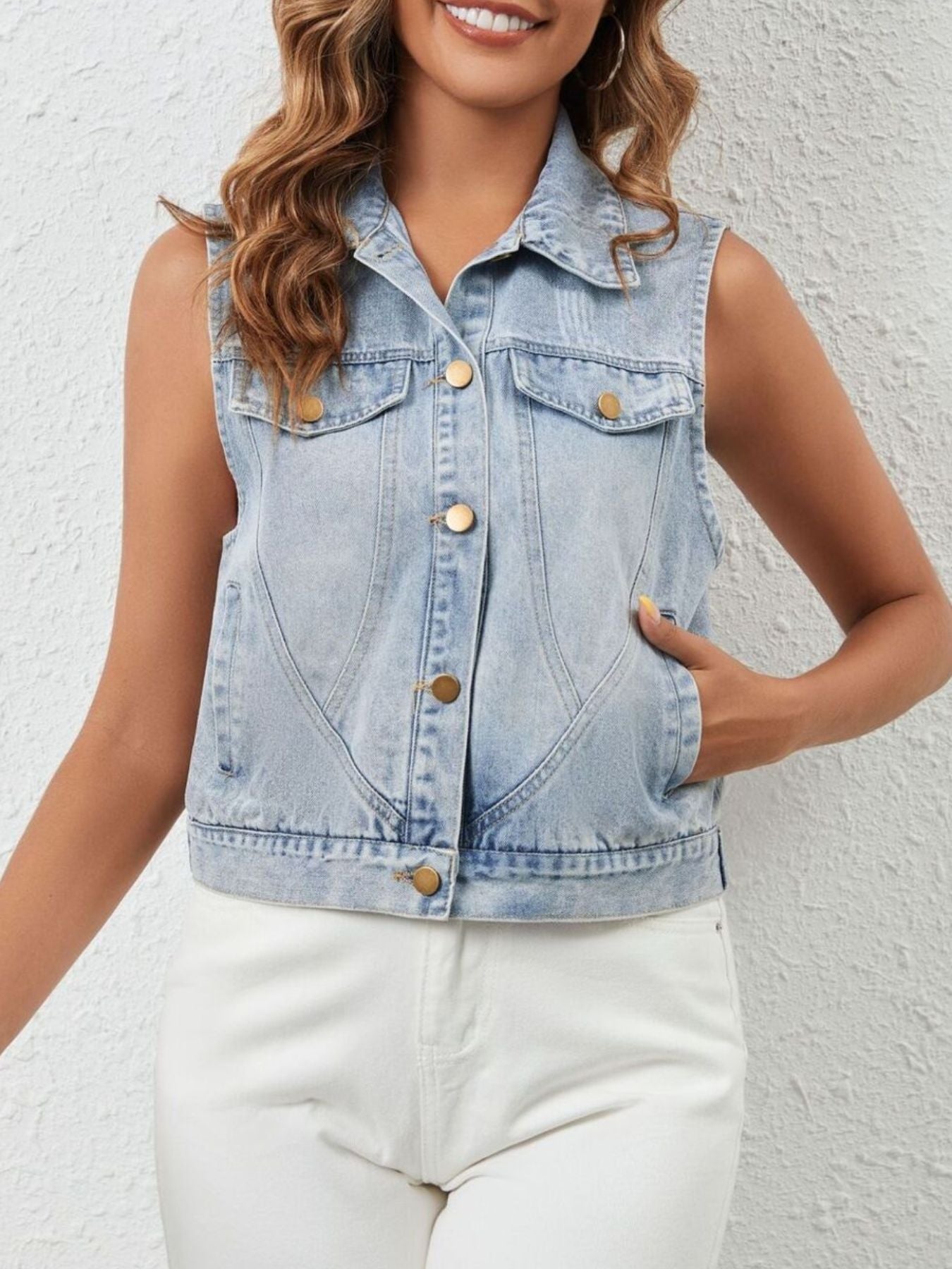 Sleeveless button-up denim jacket by Trendsi featuring classic blue denim fabric and front chest pockets.