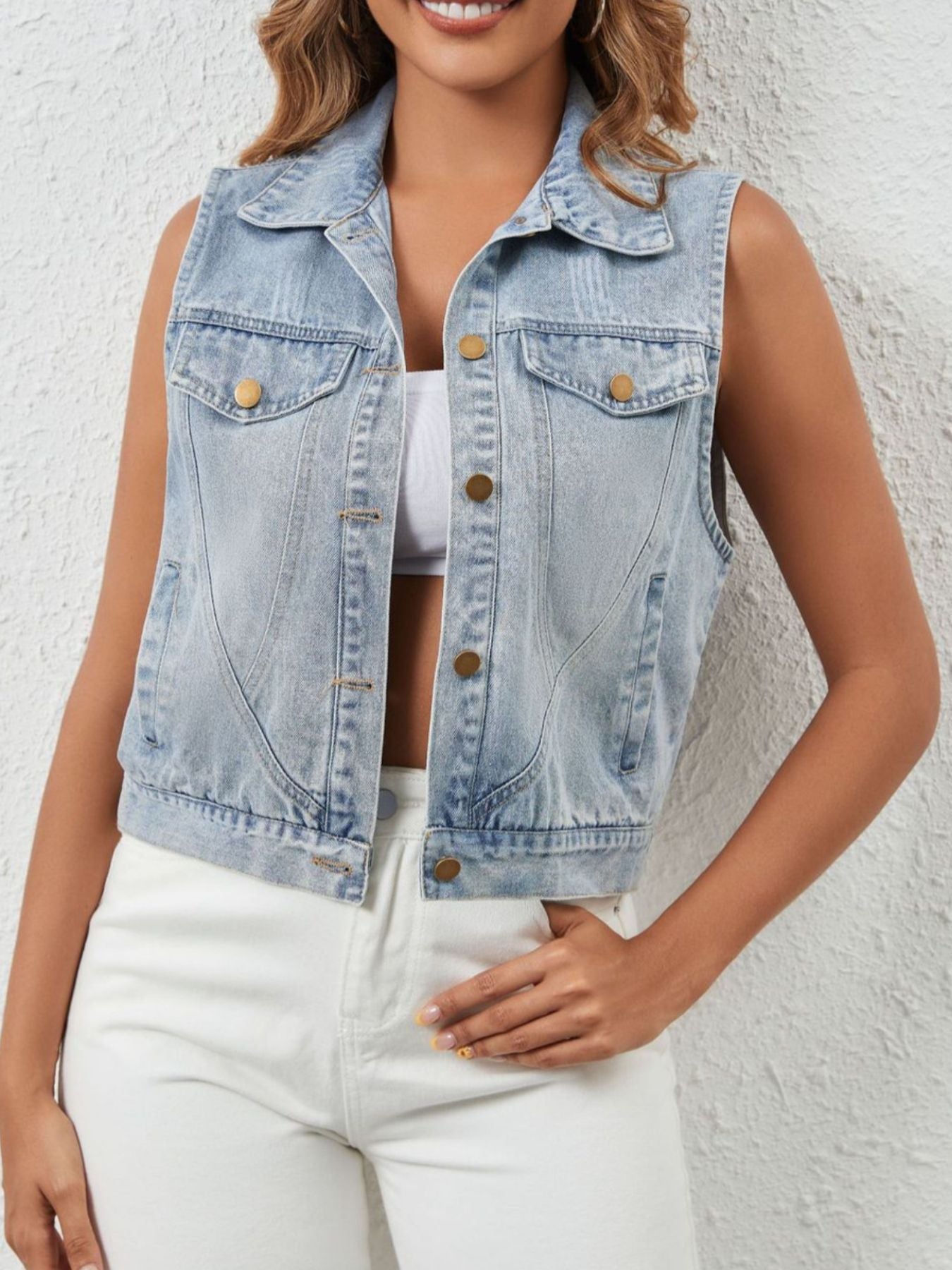 Sleeveless button-up denim jacket by Trendsi, showing front view with classic collar and metal buttons on light blue denim fabric.