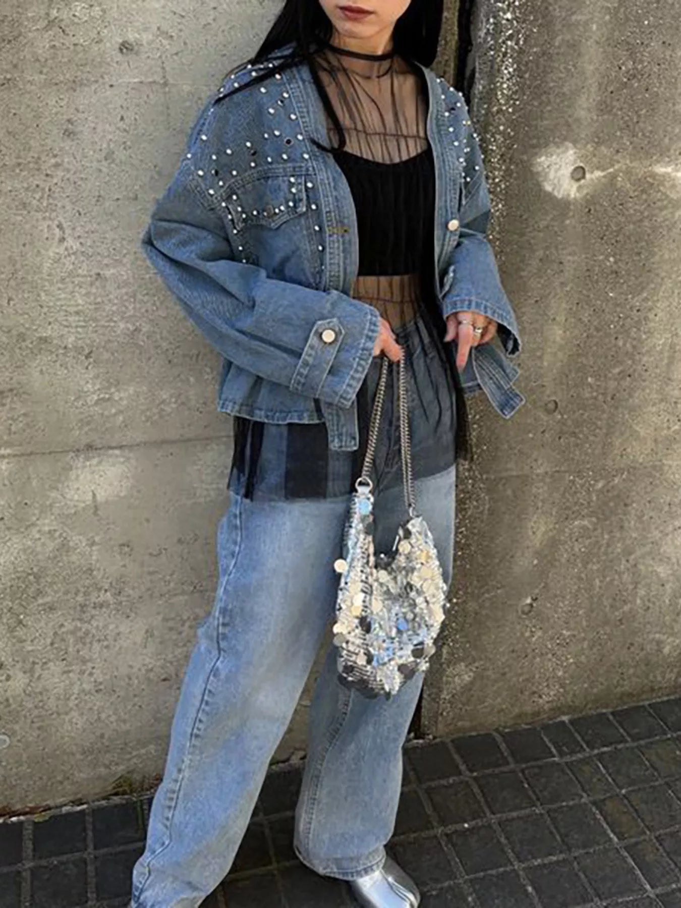 Light blue studded button-up denim jacket by Trendsi, featuring metal studs on the collar and front for a stylish casual look.