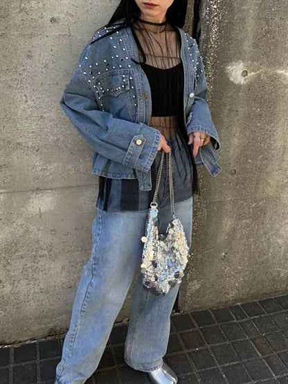 Light blue studded button-up denim jacket by Trendsi, featuring metal studs on the collar and front for a stylish casual look.