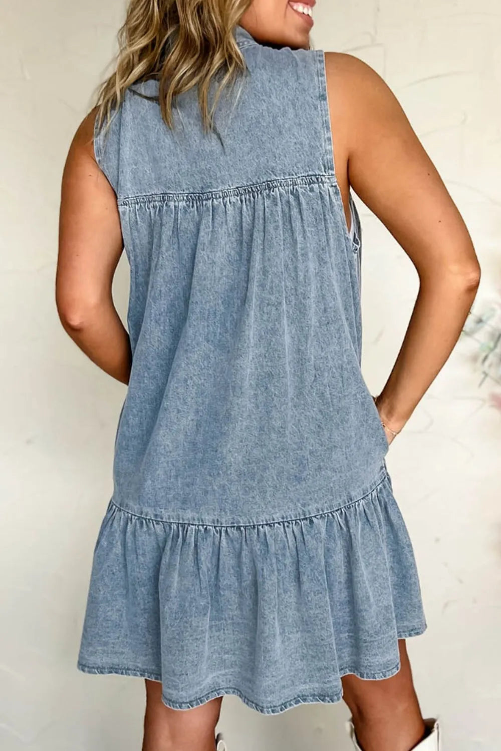 Light blue sleeveless denim dress with tie neck from Trendsi, featuring a casual fit and classic denim texture.