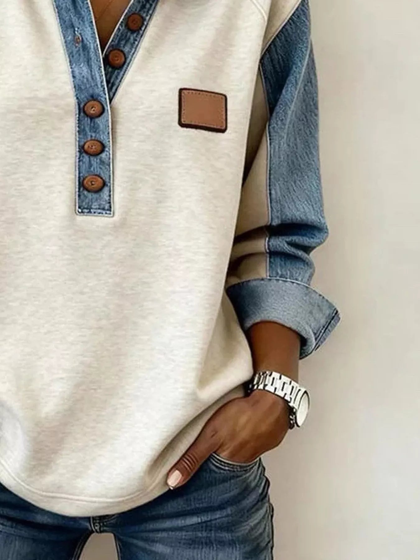 Light gray denim trim sweatshirt with button details by Trendsi, featuring a casual fit and stylish accents.
