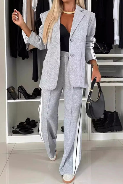 Full size contrast lapel collar top and pants set by Trendsi, featuring a stylish coordinated outfit with a lapel collar design.