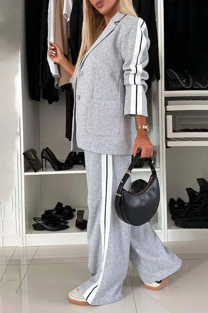 Full size contrast lapel collar top and pants set by Trendsi, featuring a stylish tailored look and coordinating design.