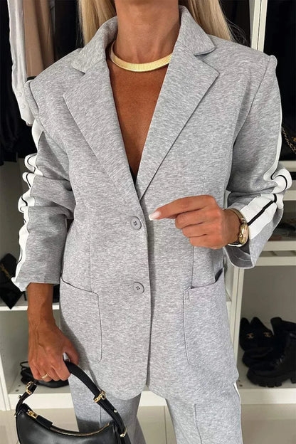 Full size contrast lapel collar top and pants set by Trendsi, featuring a stylish coordinated outfit with a lapel collar design.