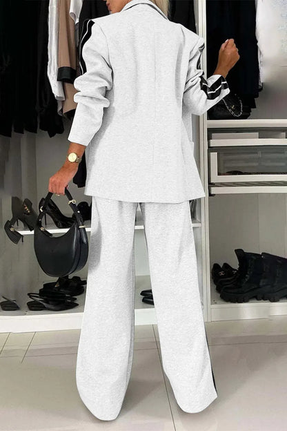 Full size contrast lapel collar top and pants set by Trendsi, featuring a stylish matching outfit with a lapel collar and tailored fit.