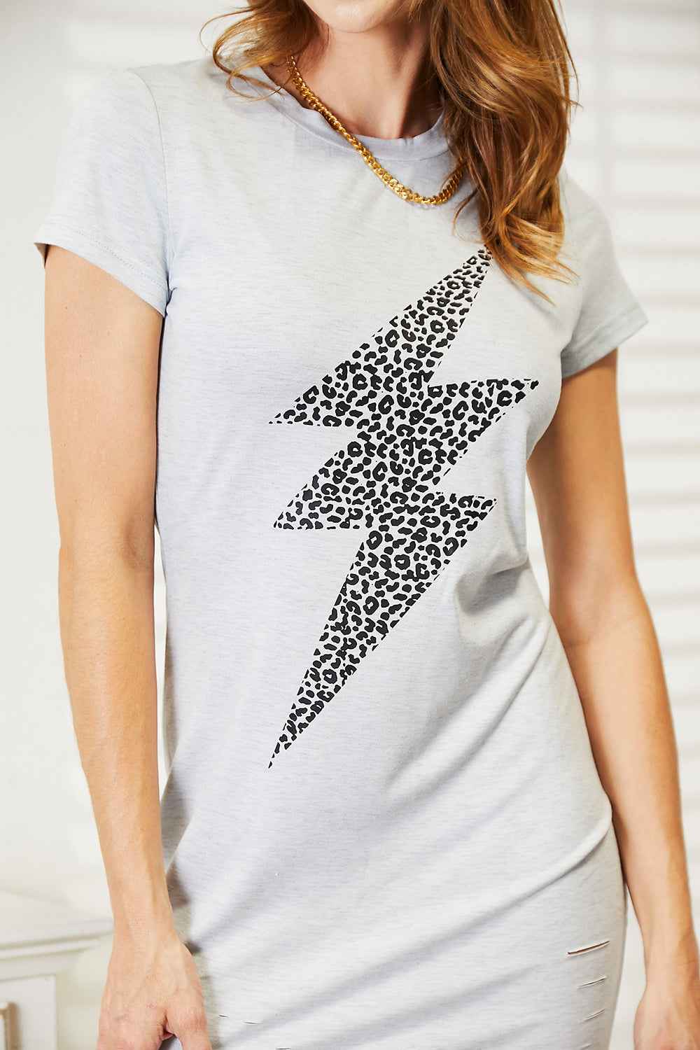 Light gray leopard lightning graphic dress by Trendsi, featuring a stylish and edgy design perfect for casual or trendy outfits.