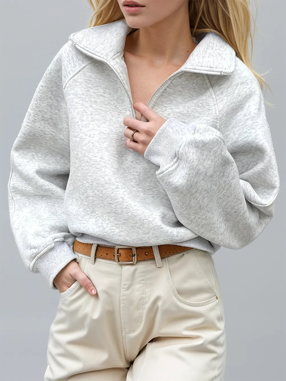 Light gray Trendsi half zip long sleeve sweatshirt with a relaxed fit and ribbed cuffs, displayed on a hanger.