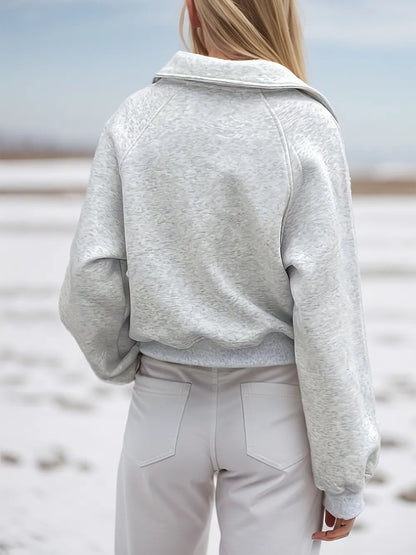 Light gray Trendsi half zip long sleeve sweatshirt with a fitted design, suitable for casual wear and layering.