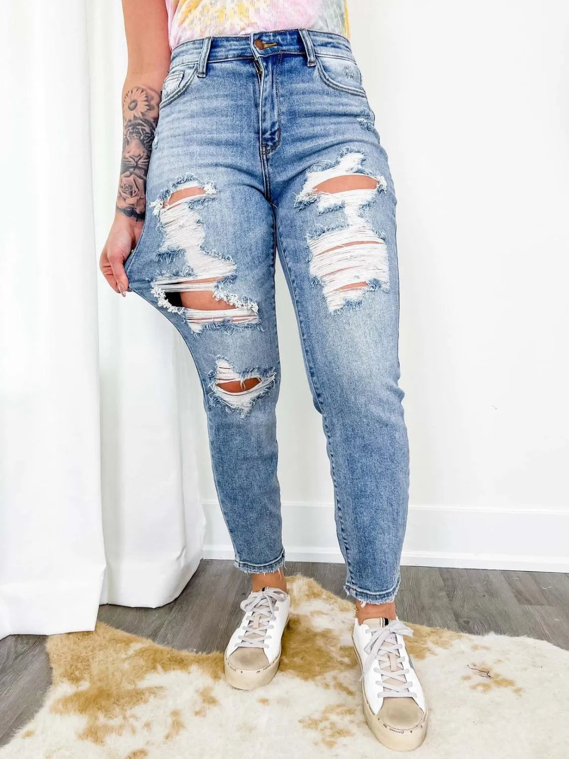 Light wash distressed skinny jeans from Trendsi, featuring rips and frayed details, fitted silhouette, and classic five-pocket design.