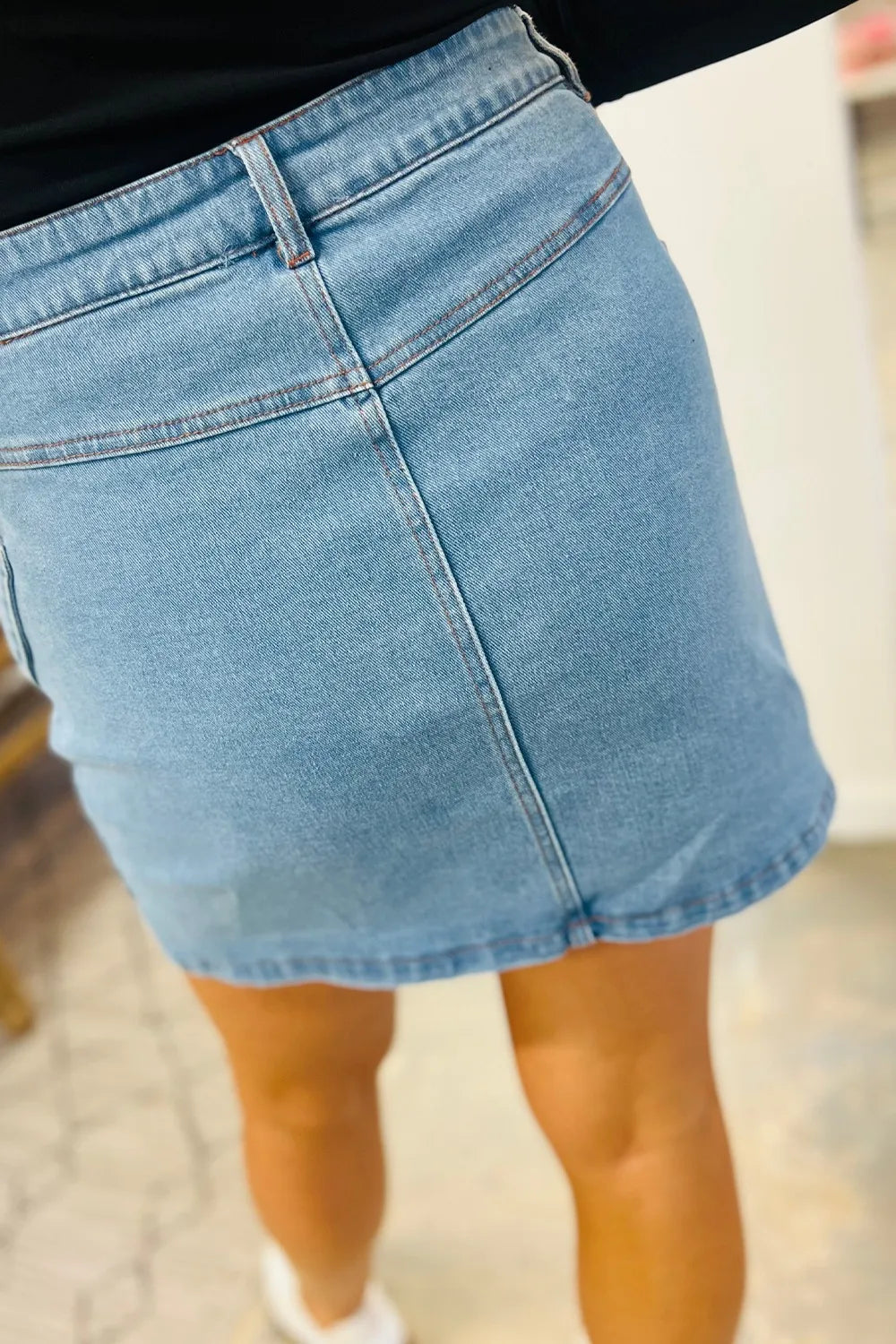 Medium acid wash high waist denim skirt with bowknot details from Trendsi, featuring a stylish and trendy design.